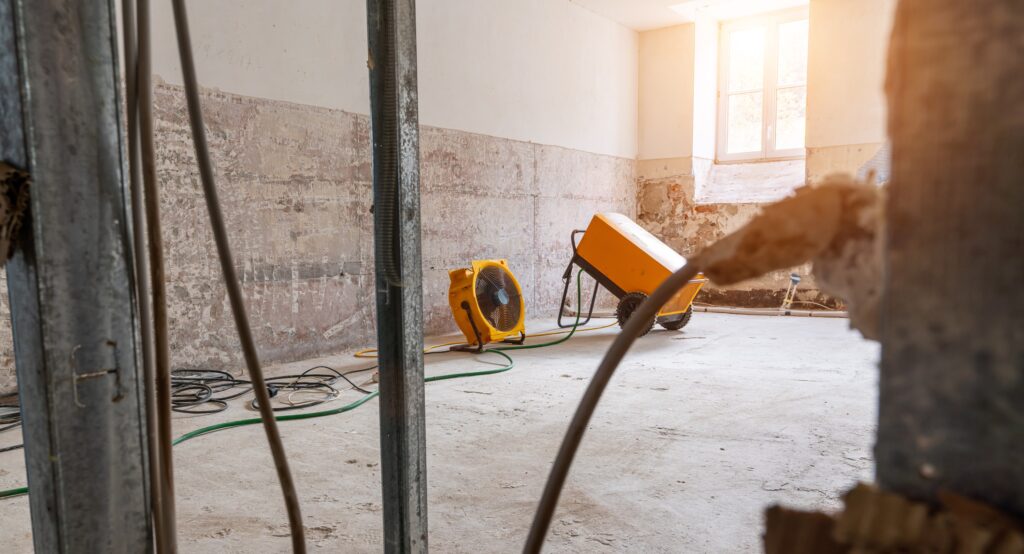 Rebuilding an Old real estate apartment, prepared and ready for renovate after flood damage, with an industrial fan and drying equipment.